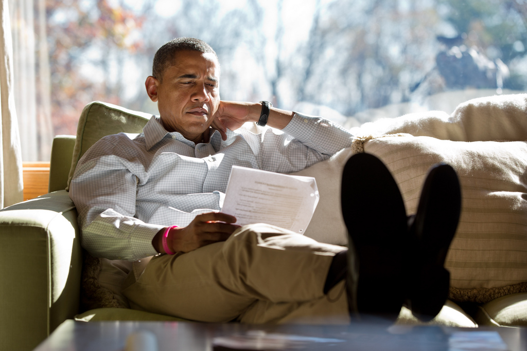 <p>President Barack Obama reads briefing material while meeting with advisors inside his cabin at Camp David, Sunday, Oct. 21, 2012.<br />
(Official White House Photo by Pete Souza)<br />
<br />
This official White House photograph is being made available only for publication by news organizations and/or for personal use printing by the subject(s) of the photograph. The photograph may not be manipulated in any way and may not be used in commercial or political materials, advertisements, emails, products, promotions that in any way suggests approval or endorsement of the President, the First Family, or the White House.</p>