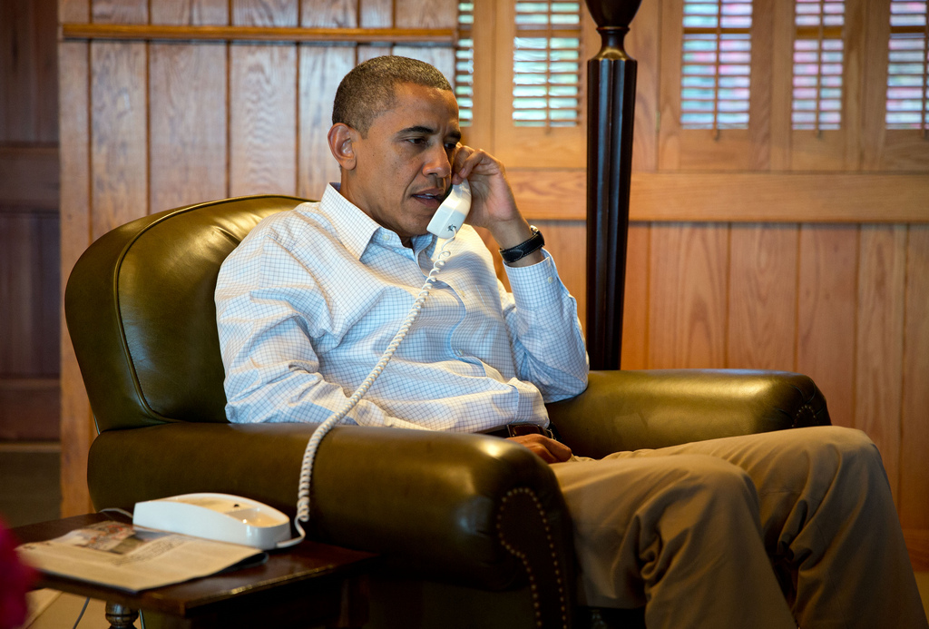 <p>President Barack Obama convenes a conference call at Camp David with Homeland Security Advisor John Brennan, FBI Director Robert Mueller and Chief of Staff Jack Lew to discuss the shooting at a Wisconsin shopping mall, Sunday, Oct. 21, 2012.<br />
(Official White House Photo by Pete Souza)<br />
<br />
This official White House photograph is being made available only for publication by news organizations and/or for personal use printing by the subject(s) of the photograph. The photograph may not be manipulated in any way and may not be used in commercial or political materials, advertisements, emails, products, promotions that in any way suggests approval or endorsement of the President, the First Family, or the White House.</p>