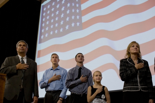 Secretary Duncan Stands during the National Anthem 