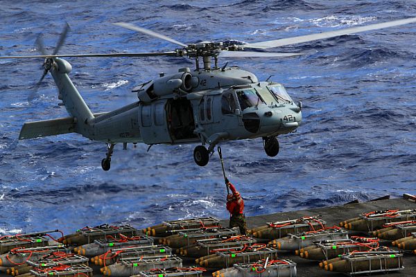 An MH-60S Sea Hawk helicopter assigned to the Dragon Whales of Helicopter Sea Combat Squadron (HSC) 28 transfers ammunition from the aircraft carrier USS Enterprise (CVN 65) to the Military Sealift Command dry cargo and ammunition ship USNS Sacagawea (T-AKE 2) during the carrier's last ammunition offload before returning to homeport. Enterprise is completing its final scheduled deployment to the U.S. 5th and 6th Fleet areas of responsibility in support of maritime security operations and theater security cooperation efforts. America's Sailors are Warfighters, a fast and flexible force deployed worldwide. Join the conversation on social media using #warfighting.  U.S. Navy photo by Information Systems Technician 1st Class Stephen Wolff (Released)  121025-N-ZZ999-084