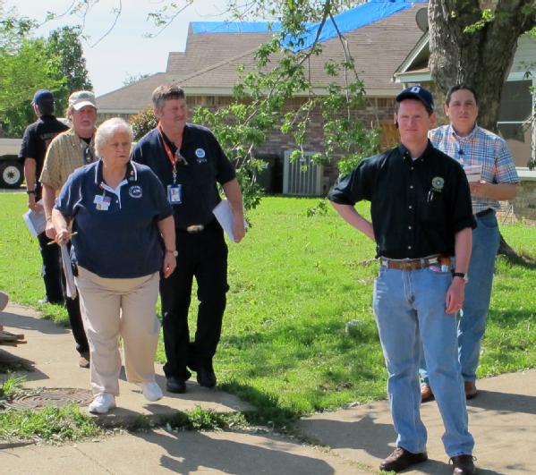 Lancaster, Texas, April 6, 2012 -- Dallas County Judge Clay Jenkins (r) leads state and federal team members through a tornado stricken neighborhood as part of the damage assessment process. Joint preliminary damage assessments are ongoing following the tornadoes that struck the Dallas-Fort Worth area.