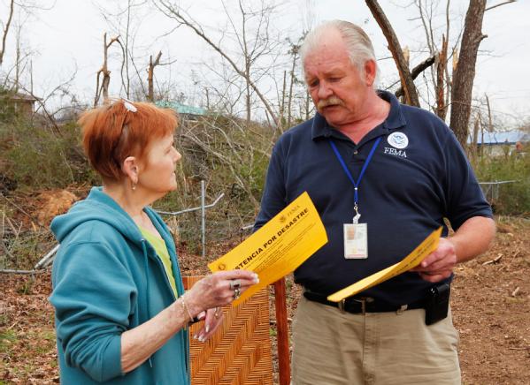 Center Point, Ala., Feb. 3, 2012 -- Duane Marusa, Especialista de Relaciones con la Comunidad, explica el proceso de inscripción a un sobreviviente de la tormenta de Center Point, Alabama. FEMA está apoyando la recuperación de las tormentas severas, tornados, vientos directos e inundaciones que dañaron o destruyeron partes de Alabama durante el periodo del 22 y 23 de enero de 2012.