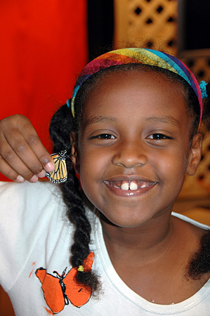 Smiling girl with monarch