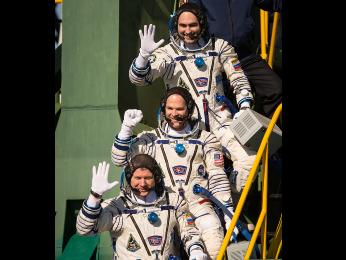 Expedition 33/34 crew members, Soyuz Commander Oleg Novitskiy, bottom, Flight Engineer Kevin Ford of NASA, and Flight Engineer Evgeny Tarelkin of ROSCOSMOS, top, wave farewell before boarding their Soyuz rocket just a few hours before their launch to the ISS on Tuesday, Oct. 23, 2012.