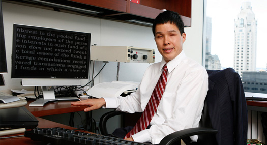 blind professional sitting at desk