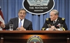 Secretary Panetta gestures as he answers a reporter's question 