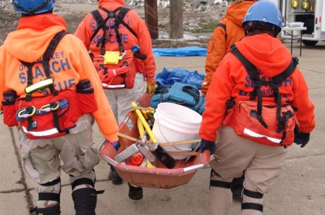 Search and Rescue team carrying supplies after a disaster