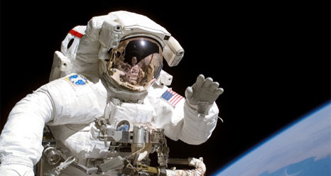 An astronaut waves during a spacewalk