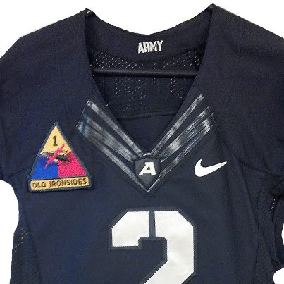 Photo: The Army Black Knights football team will be wearing the unit patch of the 1st Armored Division when they take on Kent State tomorrow. Based at Fort Bliss, TX, 1st AD is known as “Old Ironsides.” 

The distinctive insignia of the 1st Armored Division is drawn in bold colors characteristic of the division. The insignia is designed from the triangular coat-of-arms of the American World War II Tank Corps. The yellow, blue, and red colors of the insignia represent the combined arms nature of the armored division (Armor, Infantry, and Artillery). Superimposed on the triangle is the insignia of the former Seventh Cavalry Brigade (Mechanized), the predecessors of the Old Ironsides. The tank track represents mobility and armor protection, the gun denotes firepower, and the chain of lightening symbolizes speed and shock action. Mobility, firepower, and shock action are the basic attributes of Armor. The Arabic numeral in the apex of the triangle indicates the First Armor Division. The nickname of the division, officially sanctioned by The U.S. Army is emblazoned under the triangle and is an integral part of the insignia.
