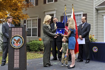 Allison A. Hickey, Veterans Affairs undersecretary for benefits, awards the department's 20 millionth home loan to Elizabeth Carpenter, the widow of Army Cpt. Matthew Carpenter, at her new home in Woodbridge, Va., Oct. 26, 2012. President Franklin D. Roosevelt launched the VA's home loan program when he signed the G.I. Bill of Rights in 1944. Carpenter's son, Joey, stands by his mother.