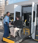 MetroAccess driver assisting a customer with a wheelchair lift