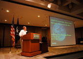 photograph of a scientist at a lecture podium