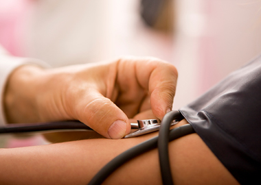 Stock photo of doctor using stethoscope on patient