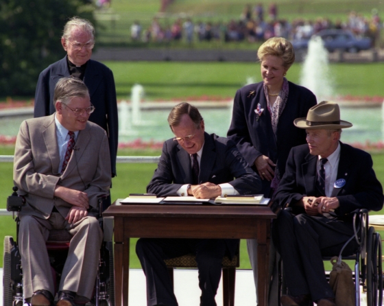 George Bush signing the Americans with Disabilities Act of 1990 