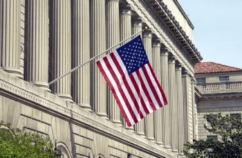 U.S. flag over Commerce headquarters