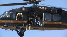 Air agents from the Office of Air and Marine's Tucson Air Branch prepare from a Blackhawk helicopter to began a rescue mission of an illegal alien stranded on a ledge of the Cerro Colorado Mountains near Arivaca, Ariz.