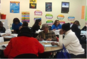 During a workshop, family members discuss ways to support their children’s education.