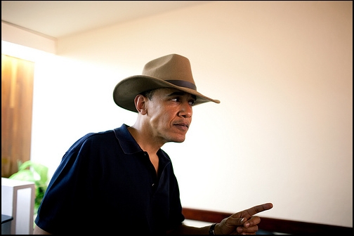 President Barack Obama jokingly shows off the hat he was given 