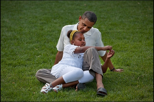 President Barack Obama sits with daughter Sasha