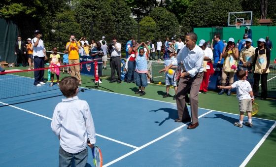 President Barack Obama hits a tennis ball during a sports clinic set up as part of the Easter Egg Roll activities 