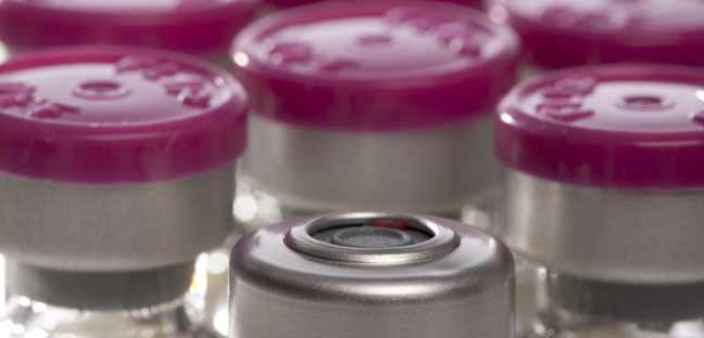 Vials of vaccine with selective focus on the foreground and white background.