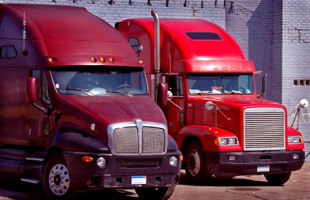 Image of the front of two trucks lined up next to each other.