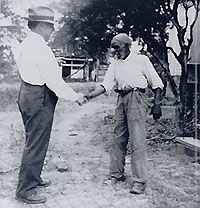 John A. Lomax shakes hands with with  Rich Brown
