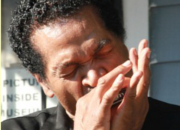 Blues Artist Bobby Rush plays a harmonica.