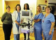 Photo of VA nurses standing in front of a ECG Waveform Tip Confirmation machine
