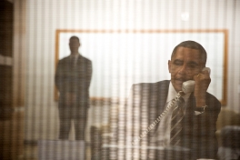 Seen through a wire screen, President Barack Obama conducts a conference call to update New York Gov. Andrew Cuomo and other New York officials on the ongoing federal government response to Hurricane Sandy, Nov. 1, 2012. The President made the call backstage at the University of Colorado in Boulder. (Official White House Photo by Pete Souza)