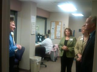 Photo: Visiting with Jill Wenger, Terri Gehring and John Worden, a pharmacist at McPherson Hospital.