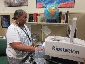 Library Technician Rene Sayles operating the Ripstation. Photo Credit: Butch Lazorchak