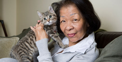 Elderly lady holding her pet cat