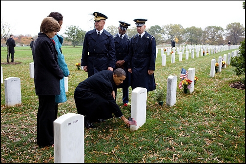 President Barack Obama leaves a presidential coin at the gravesite of 19-year-old Medal of Honor recipient