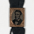 A black ribbon with a picture of Lincoln attached.