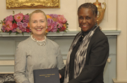 Acting Public Printer Davita Vance-Cooks presents Secretary of State Hillary Clinton a copy of Trafficking in Persons Report, which GPO produced for the State Department.