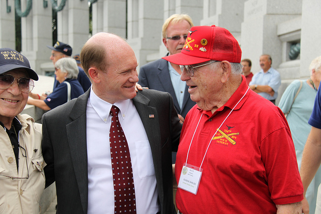 Senator Coons talks with veterans at the World War 2 Memorial. 