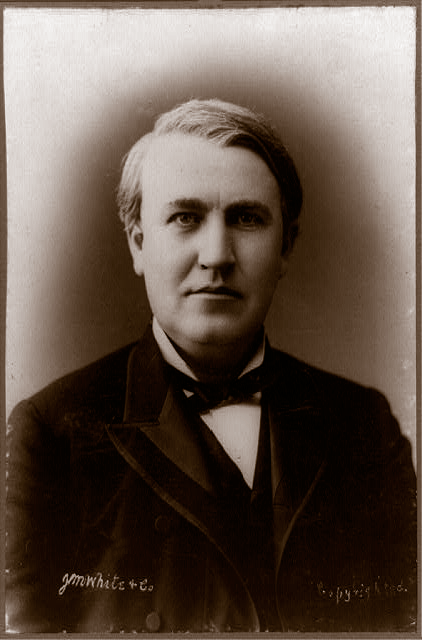 Head-shot portrait of a young Thomas Edison in a dark suit with a neckcloth
