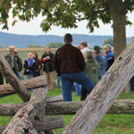 Visitors join in a battlefield hike