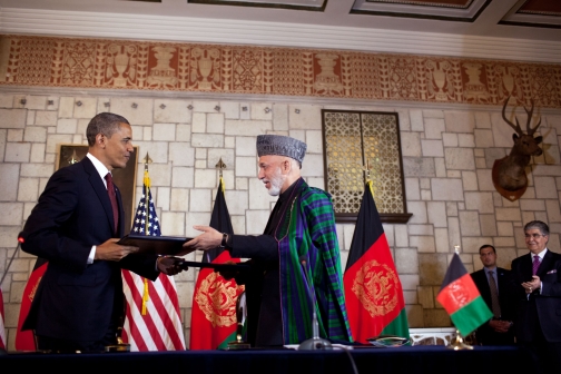President Barack Obama And Afghan President Hamid Karzai Exchange Documents