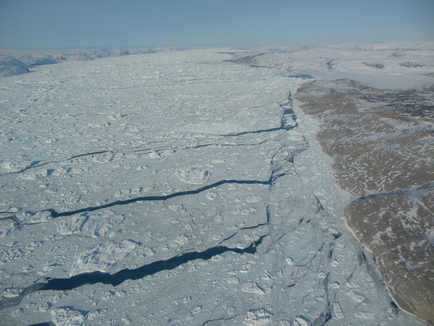 A view of sea ice with open leads of water.