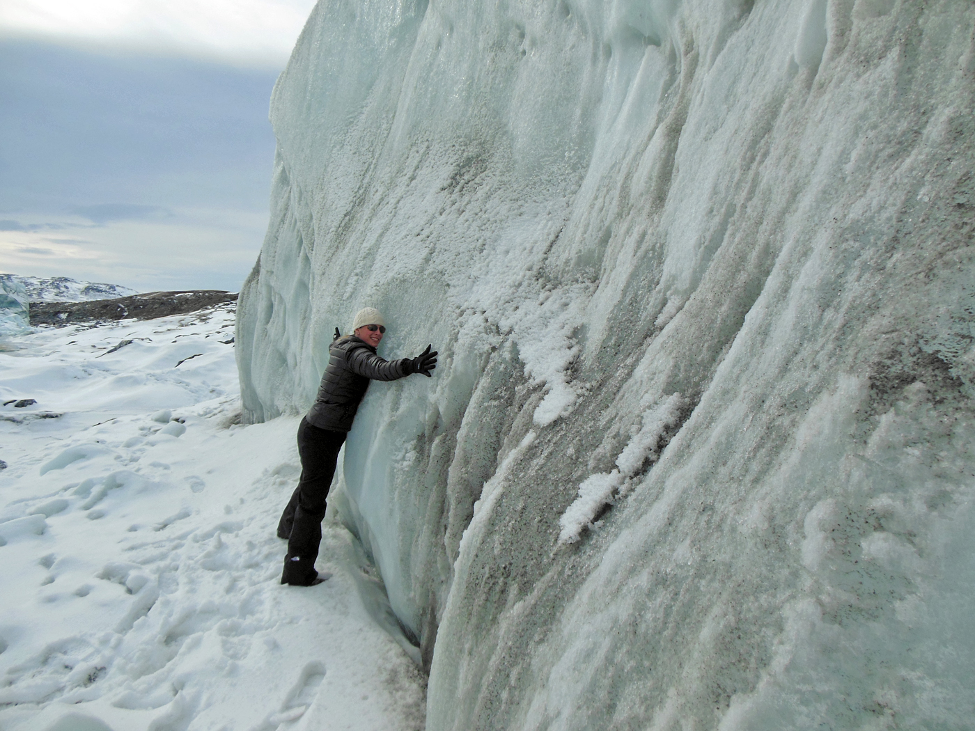 Christy Hansen hugs the Russell glacier, part of the Greenland Ice Sheet.