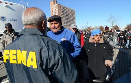 FEMA Community Relations worker explains FEMA aid to survivor of sub-tropical storm Sandy