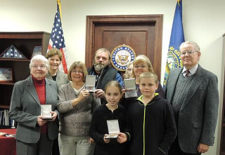 Photo: Senator Shaheen helped honor Veterans Day with a military medals ceremony to posthumously recognize World War II Veteran Henry Bolduc. Bolduc enlisted in the United States Army at the age of 22 and was stationed in New Guinea. Pictured is his family, who live in Laconia (November 9, 2012. Manchester, NH.)