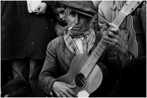Murcia, Spain: Guitar player with friend, Nov. 1952