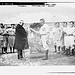 [New York Yankees president Frank Farrell presents loving cup to Yankees manager Harry Wolverton as Red Sox and Yankees players look on at Hilltop park, New York, April 11, 1912 (baseball)] (LOC)