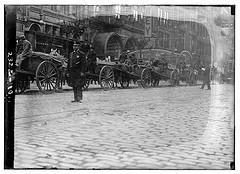 [Garbage carts protected by police during a strike, New York City] (LOC)