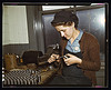 War production workers at the Vilter [Manufacturing] Company making M5 and M7 guns for the U.S. Army, Milwaukee, Wis. Ex-housewife, age 24, filing small parts. Her husband and brother are in the armed service (LOC) by The Library of Congress