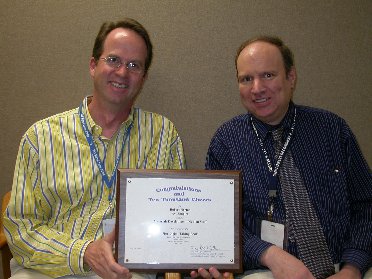 Robert Norton and Avi Shapiro holding award certificate.