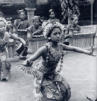 Balinese girl dances in front of the gamelan